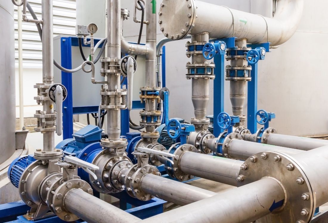 A stainless steel pharmaceutical water system is being cleaned, highlighting the importance of removing biofilm for safety and compliance.
