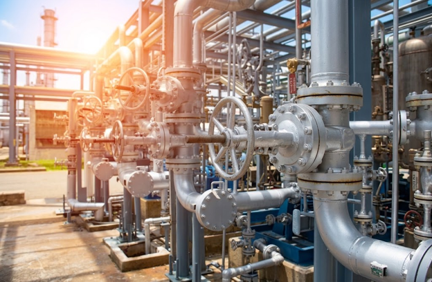 Industrial stainless steel pipework and equipment representing stainless steel chemical cleaning in a processing facility.