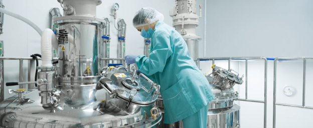 Stainless steel processing equipment in a controlled facility representing the passivation process used across different industries.